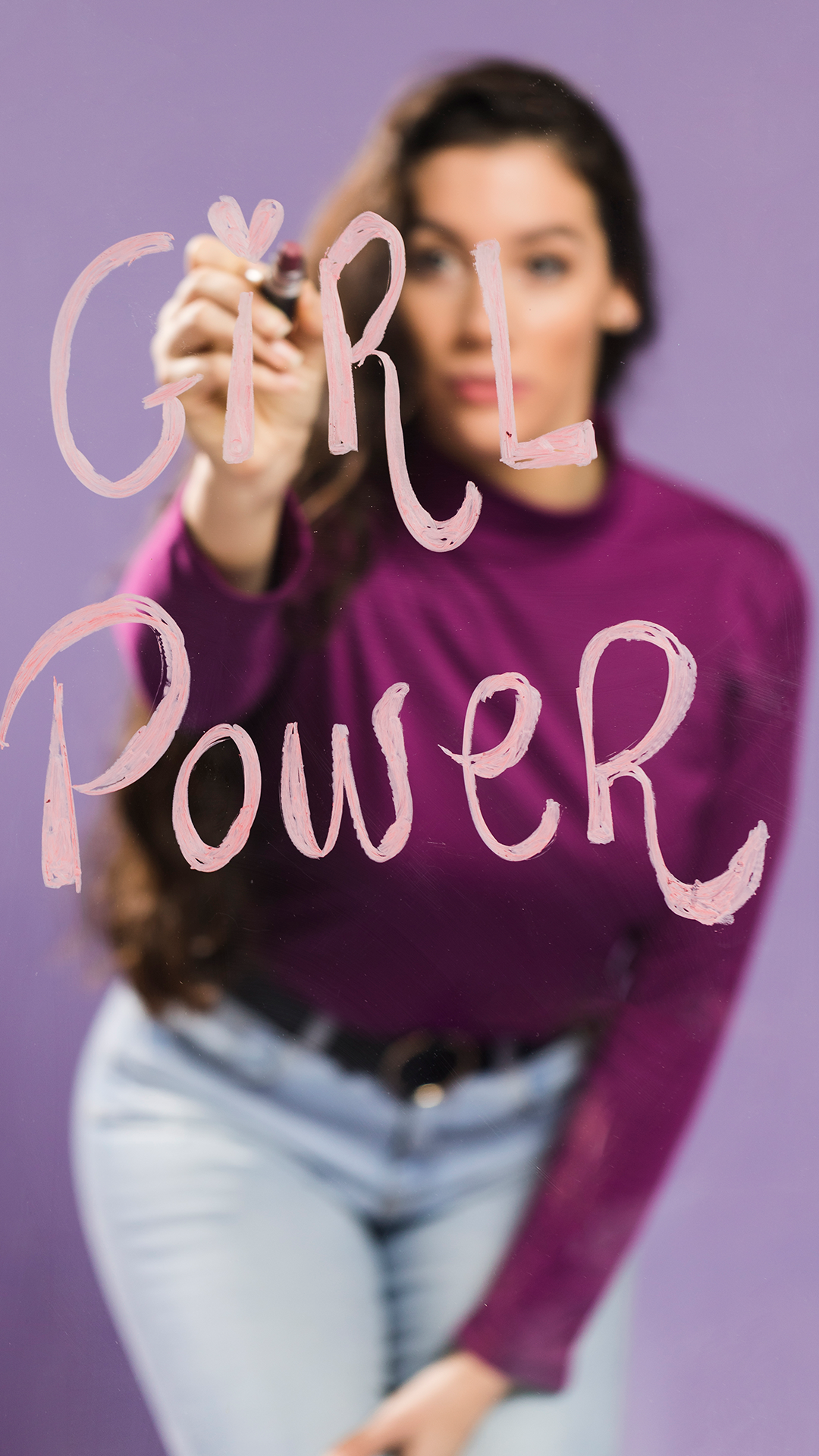 blurred-woman-writing-girl-power-transparent-glass